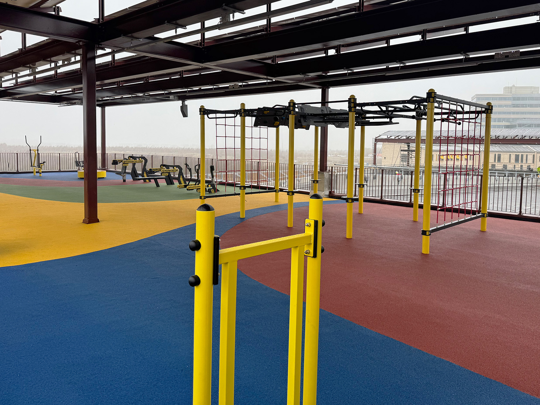 Utegymutstyr på en takterrasse med fargerikt gulv og flott utsikt